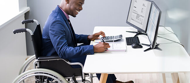 Disabled,African,Accountant,Working,On,Computer,In,Wheelchair